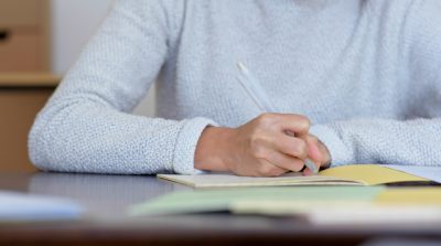 Woman write on note book at home