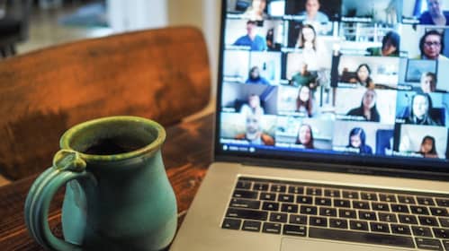 Coffee mug in front of computer screen